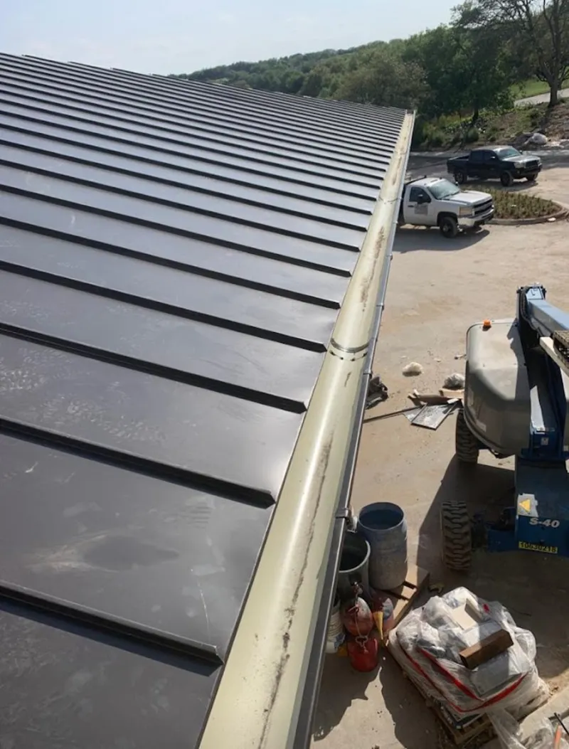 Standing seam panel and gutter detail on a metal roofing jobsite in Town and Country